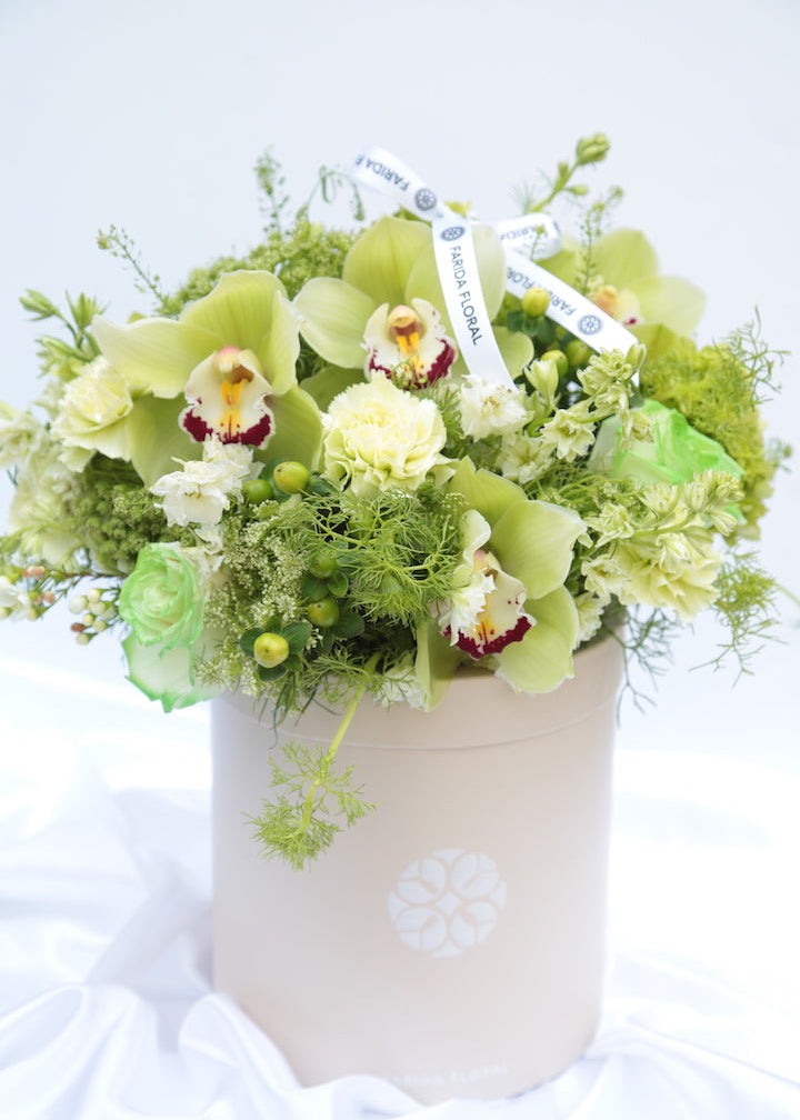 All-green garden bouquet with orchids and roses for a housewarming gift by Farida Floral, Fairfax VA