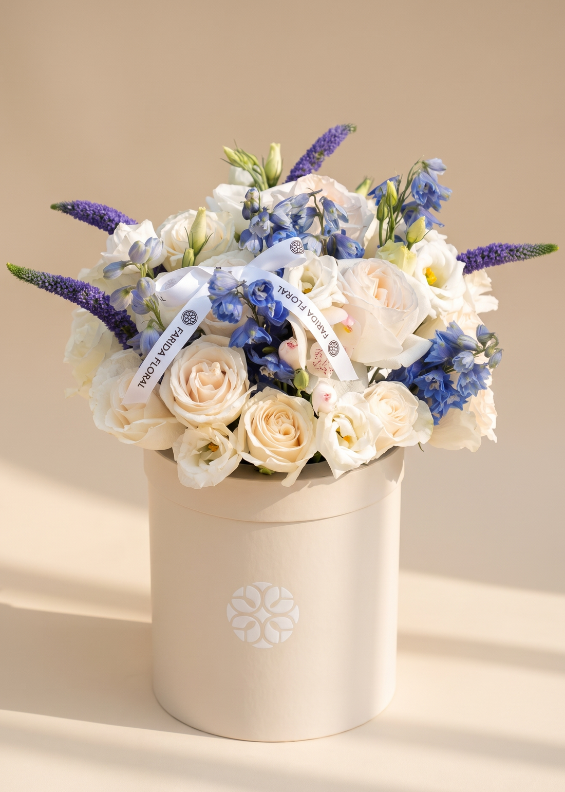 Elegant ivory and sky blue garden arrangement for a retirement gift by Farida Floral, Fairfax VA