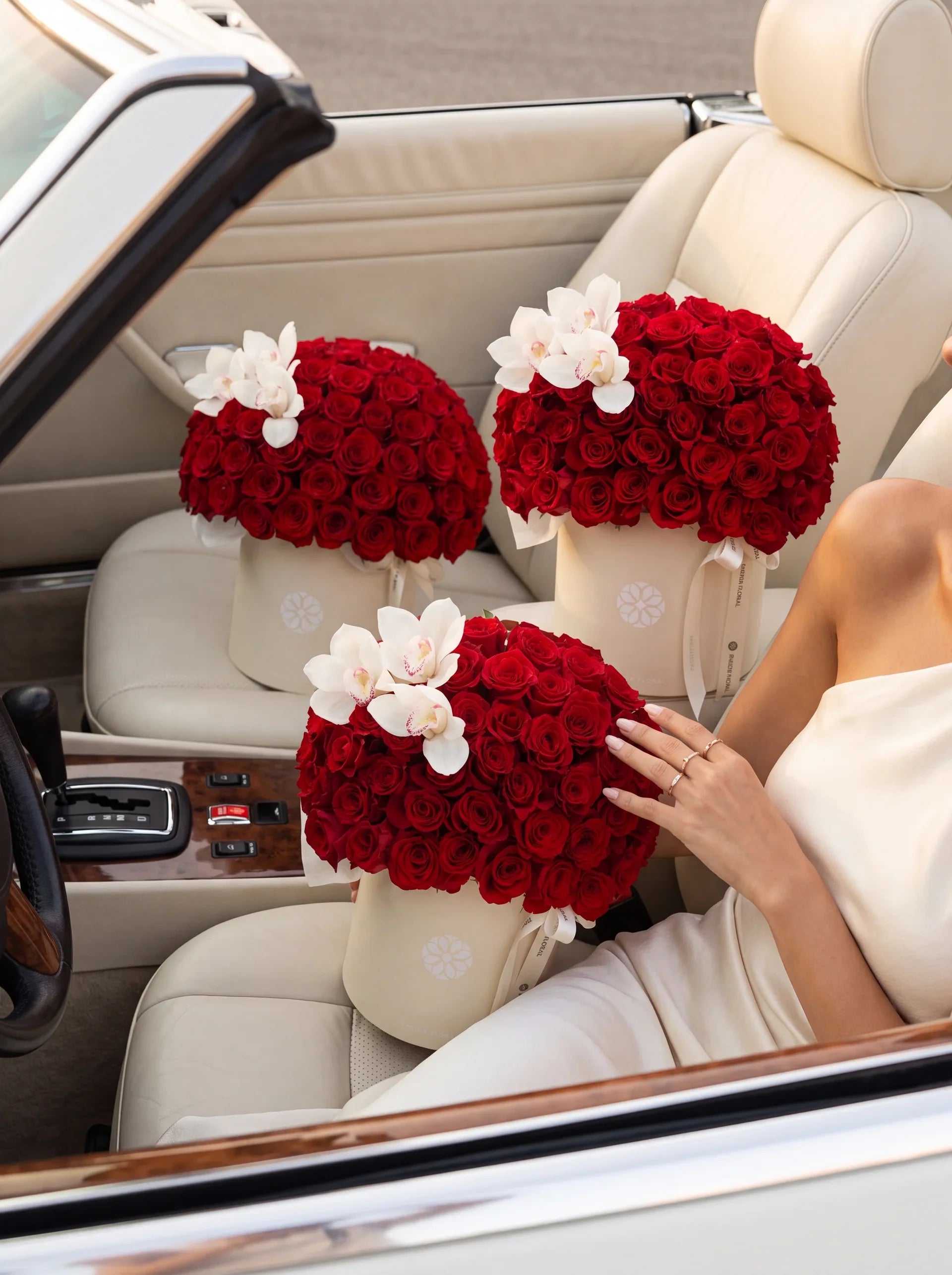 Signature Red Rose boxes in a cream convertible