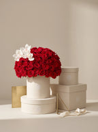 Premium Signature Red Rose box on a pedestal with gift boxes