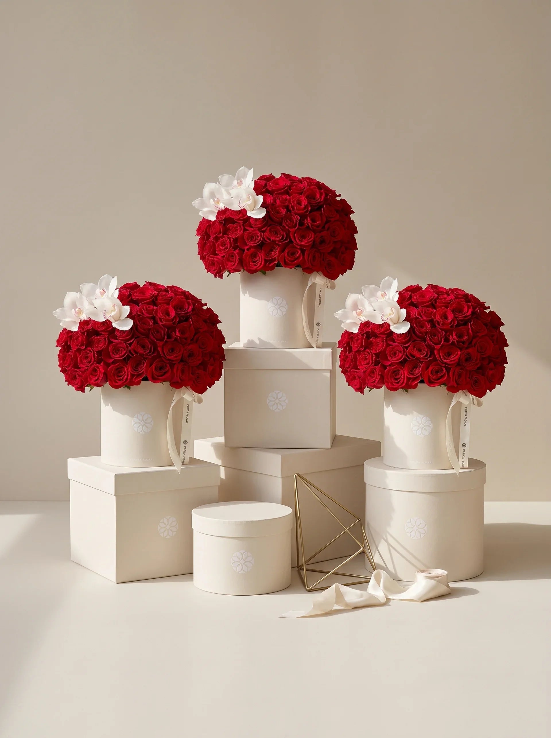 Trio of premium Farida Floral Signature Red Rose boxes on pedestals